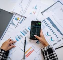 pexels-photo-7693201-7693201-1 A top view on charts and smartphone in an office, showcasing data analytics.